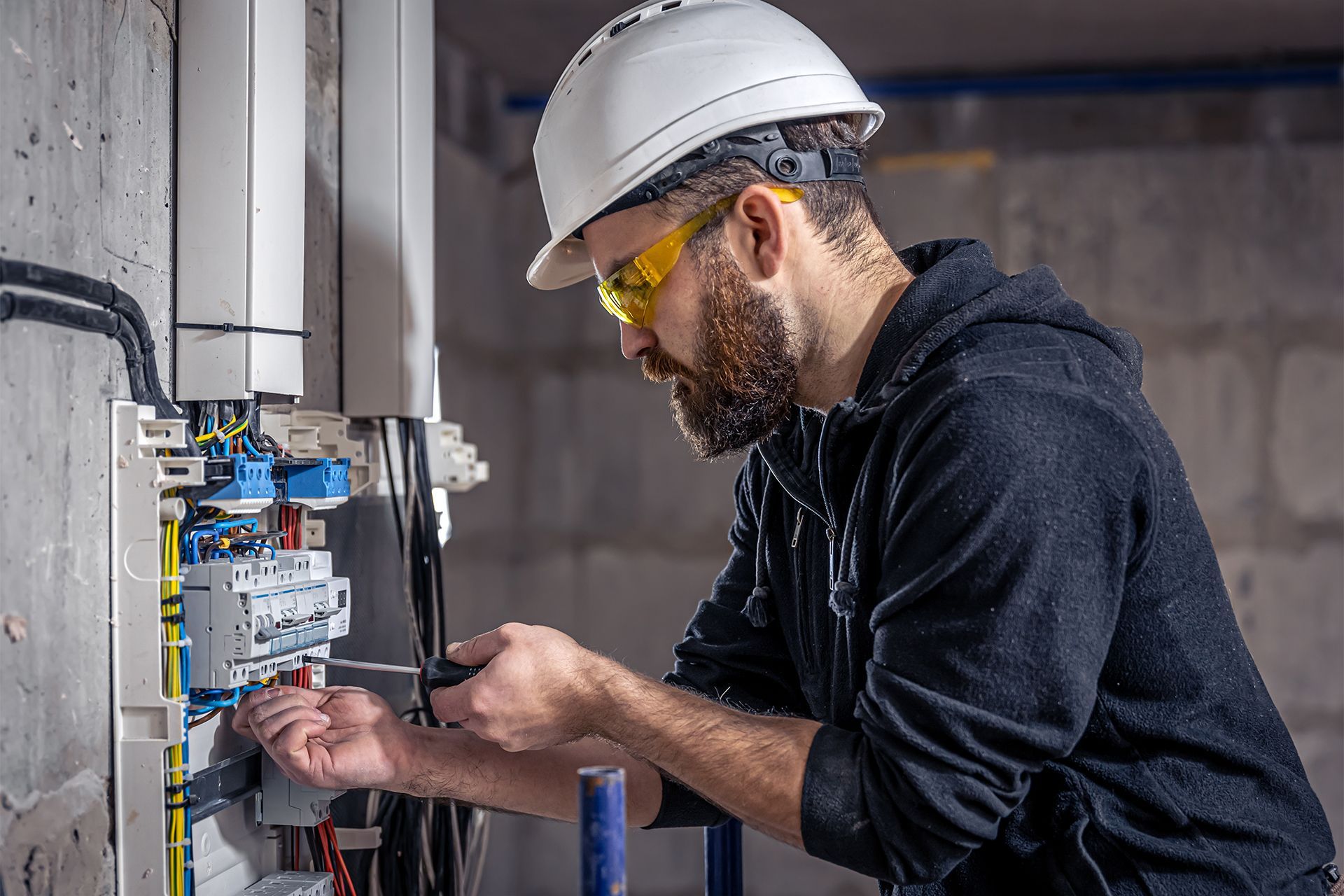 Electrician working on electrical panel — real photo builds trust