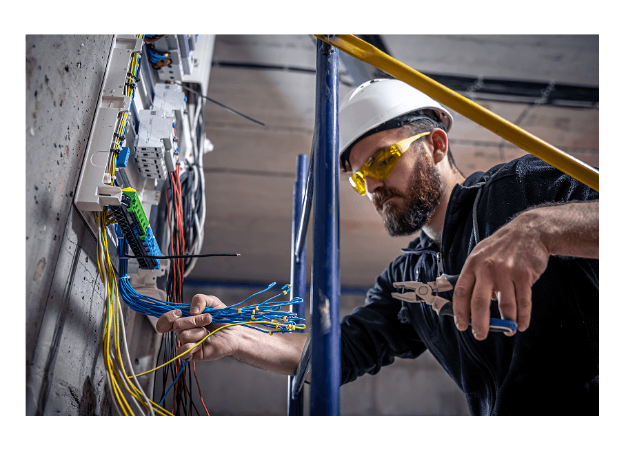 Electrician working on wiring — real job site photo